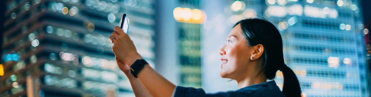 Woman on an urban street using smartphone