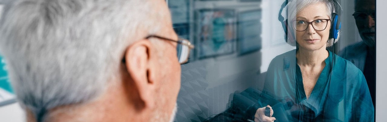A patient undergoes a hearing test in an audiology clinic.