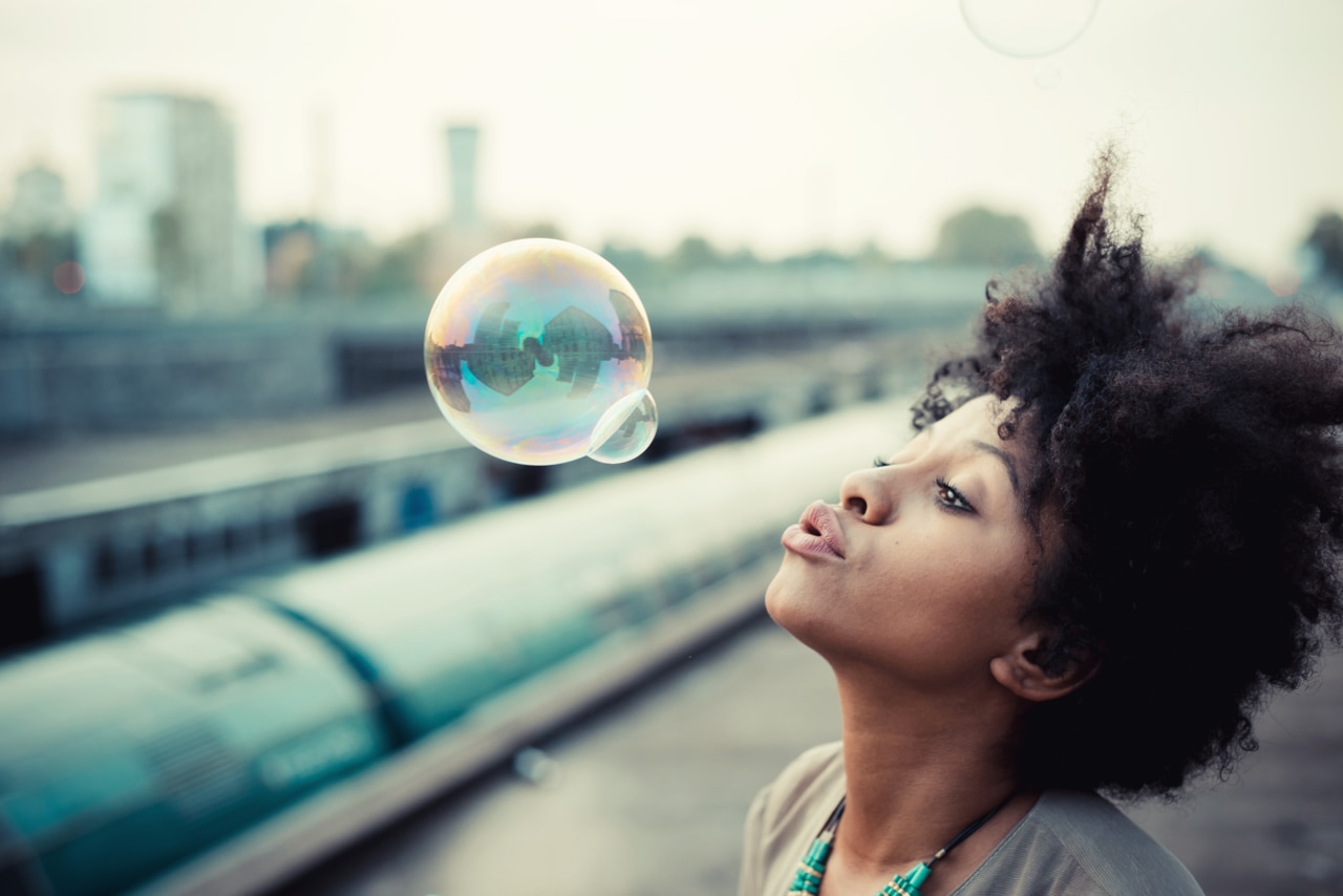 Young woman blowing bubbles