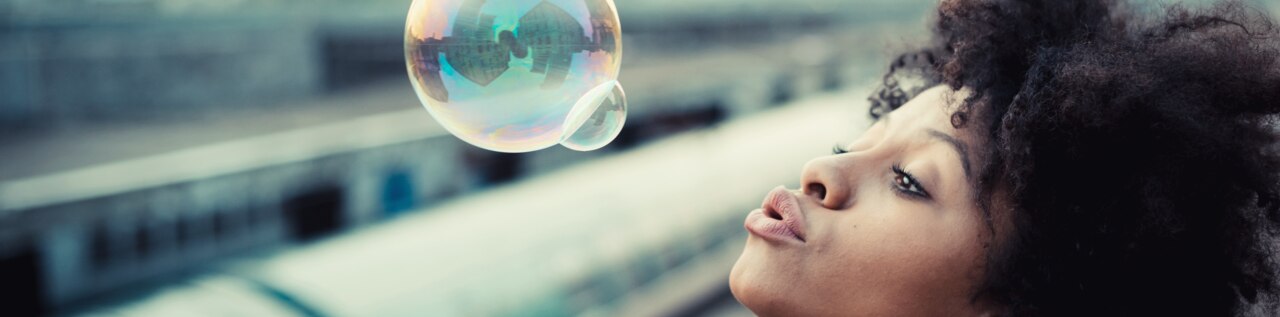 Young woman blowing bubbles